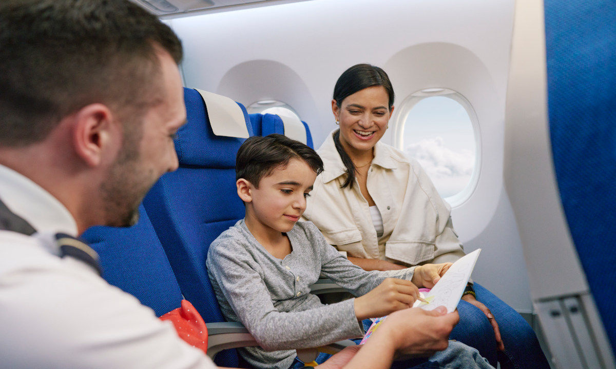 Flight attendant gives child a toy