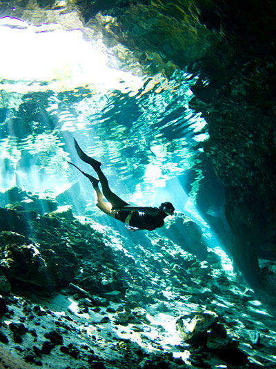 Woman diving in cenote