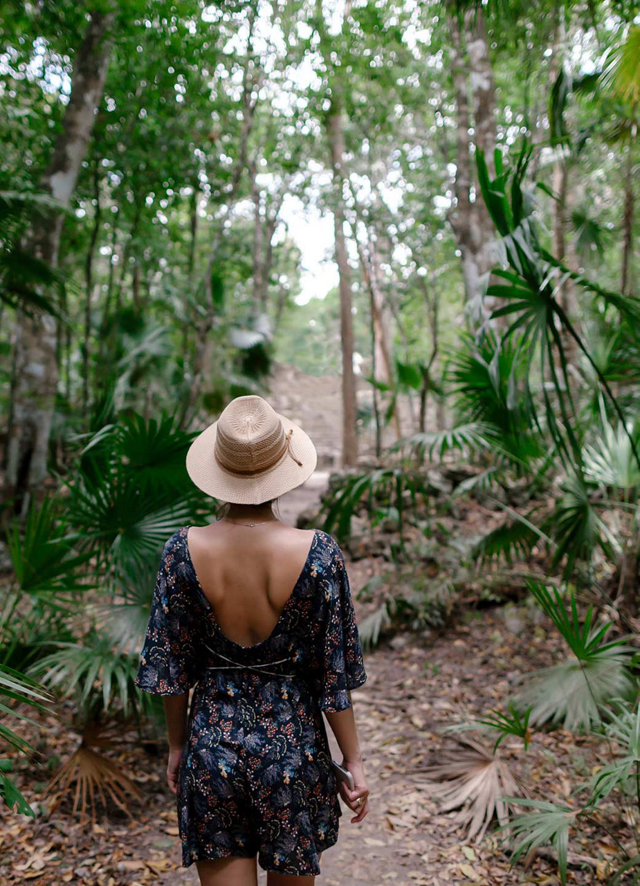 Woman walking through rain forest