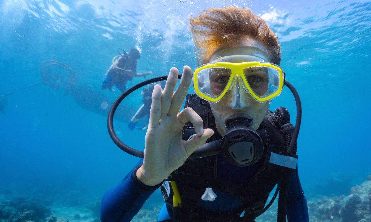 Diver making hand signals underwater.