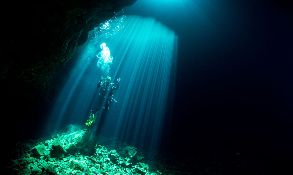 Divers in Buracona Rock Bay.