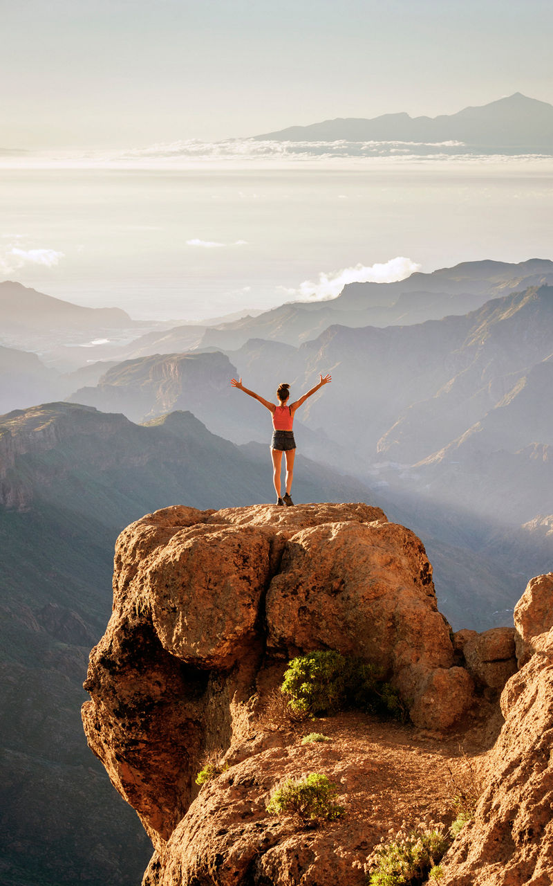 A person stands on a rock