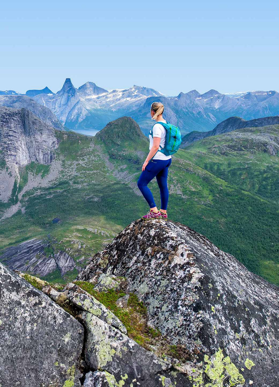 Woman on top of mountain