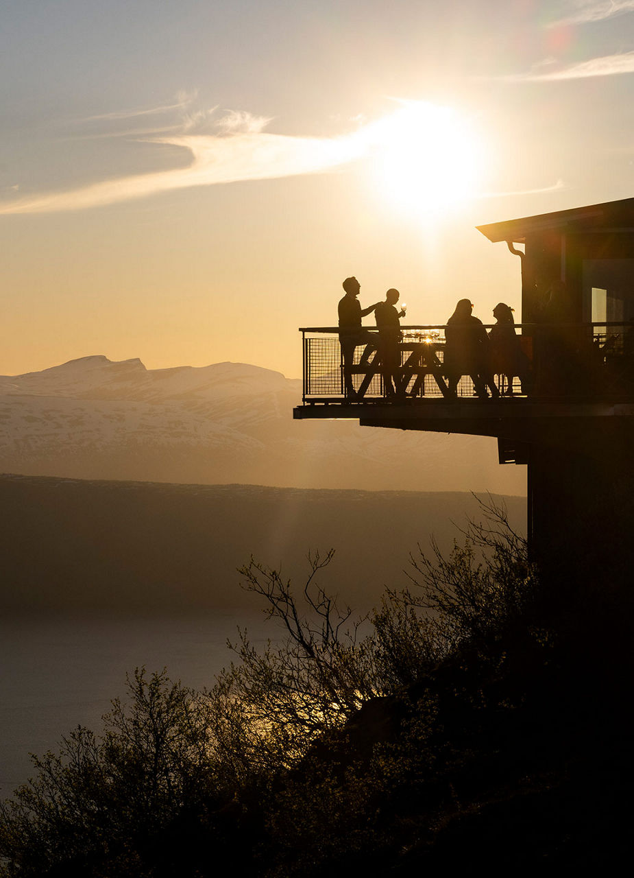 People enjoying sunset with a drink