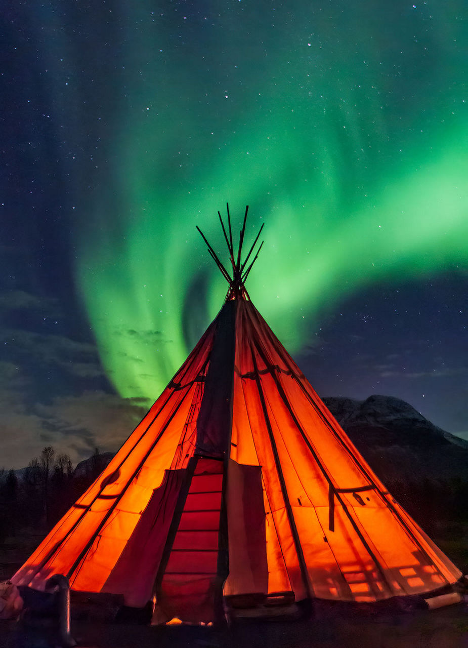 Lávvu tent with the Northern Lights in the background