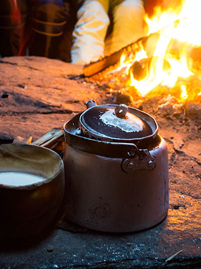 Cooking by the fire in a lávvu tent
