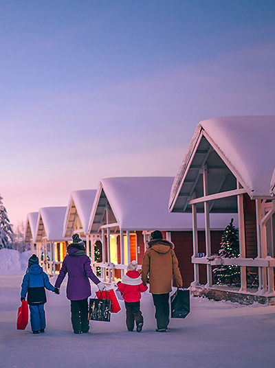 Santa Claus Holiday Village in the evening with family