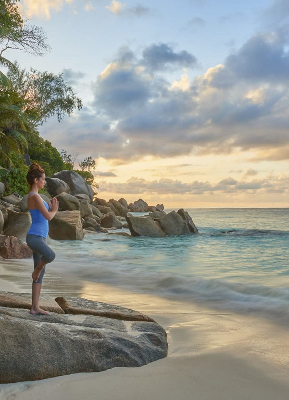 Woman doing yoga at beach