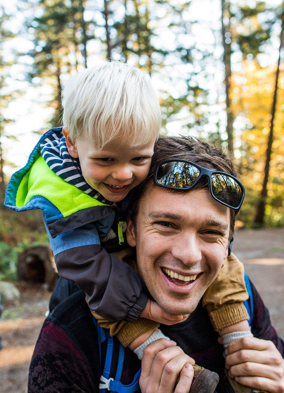 Man with his kid in the forest